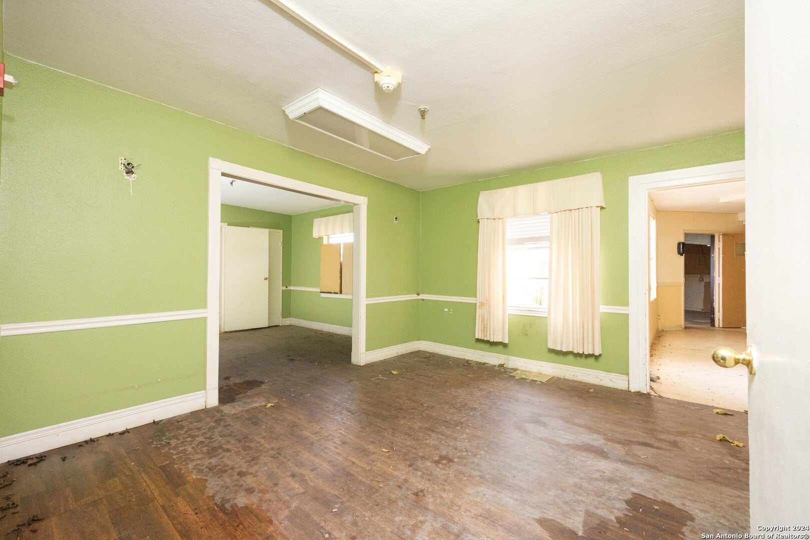 The vacant green-walled interior of the building today